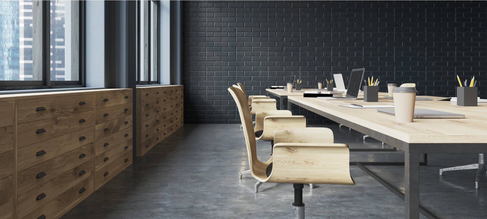 Modern office space with wooden chairs, black brick wall, and natural lighting