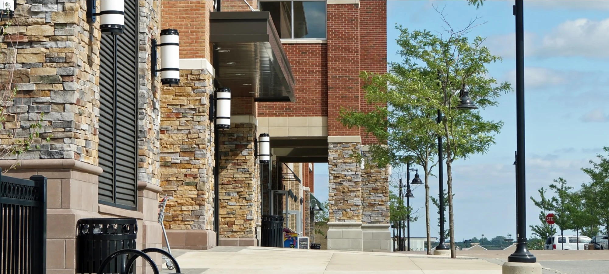 Stylish brick shopping complex with stone accents and modern outdoor lighting