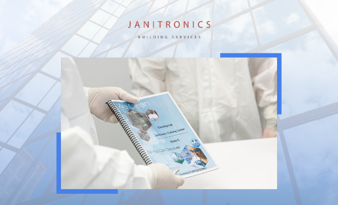 Janitronics employees in cleanroom suits review a company training manual