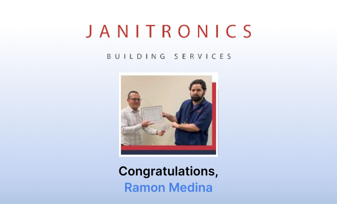 Ramon Medina receives an award in a Janitronics employee recognition event