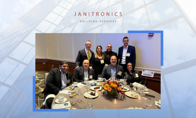 A professional gathering with Janitronics employees networking over a formal dinner