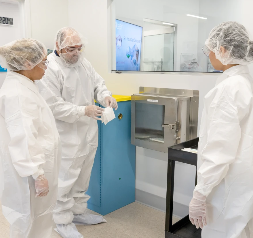Janitronics employees ensuring sterility in a laboratory setting with safety protocols